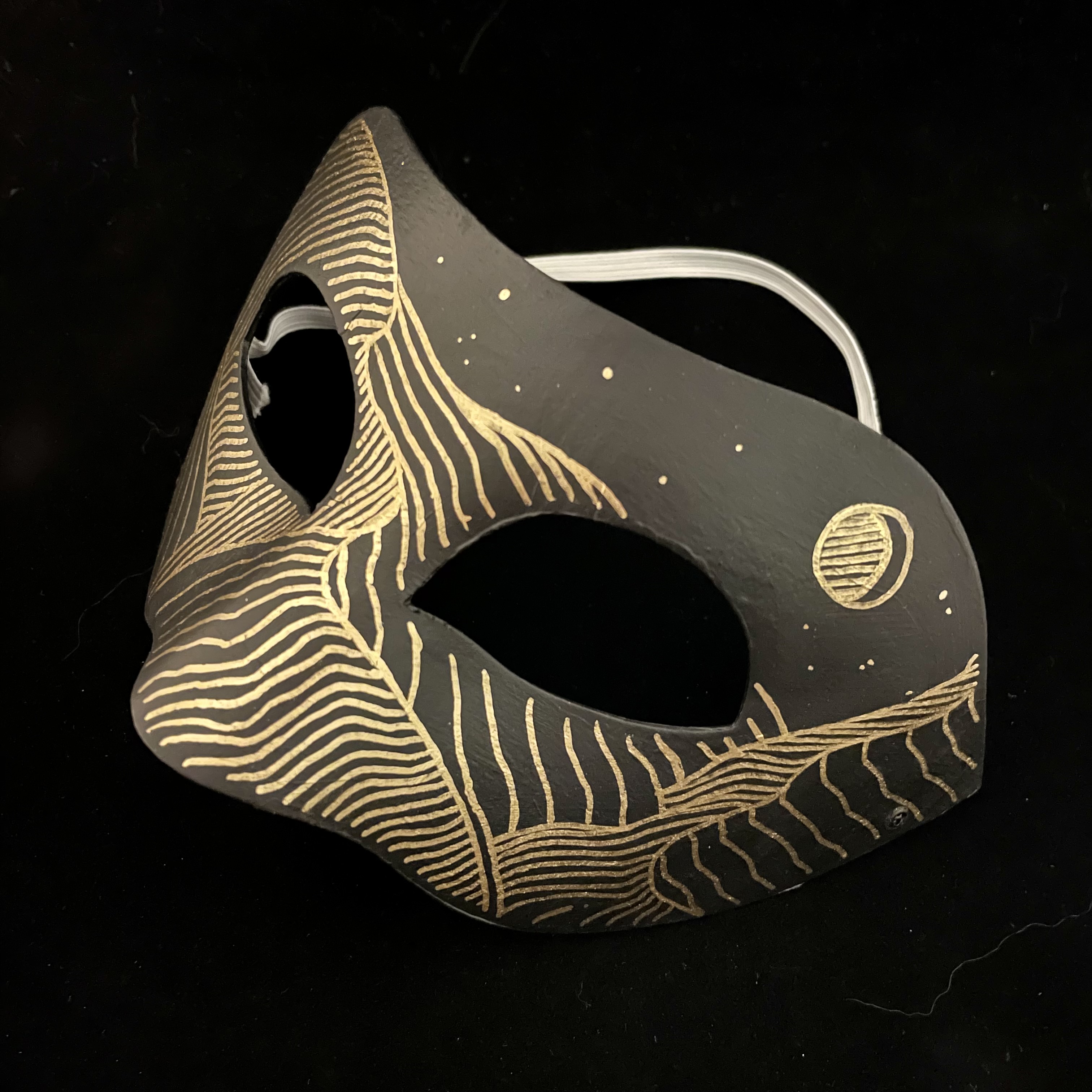 mask with hills and a moon