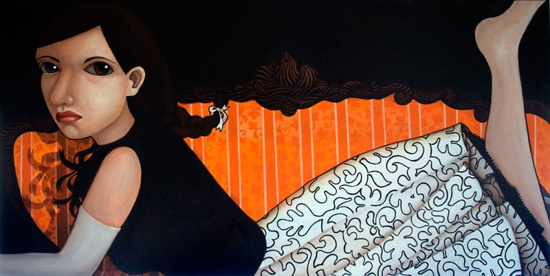 a woman lies on an orange couch