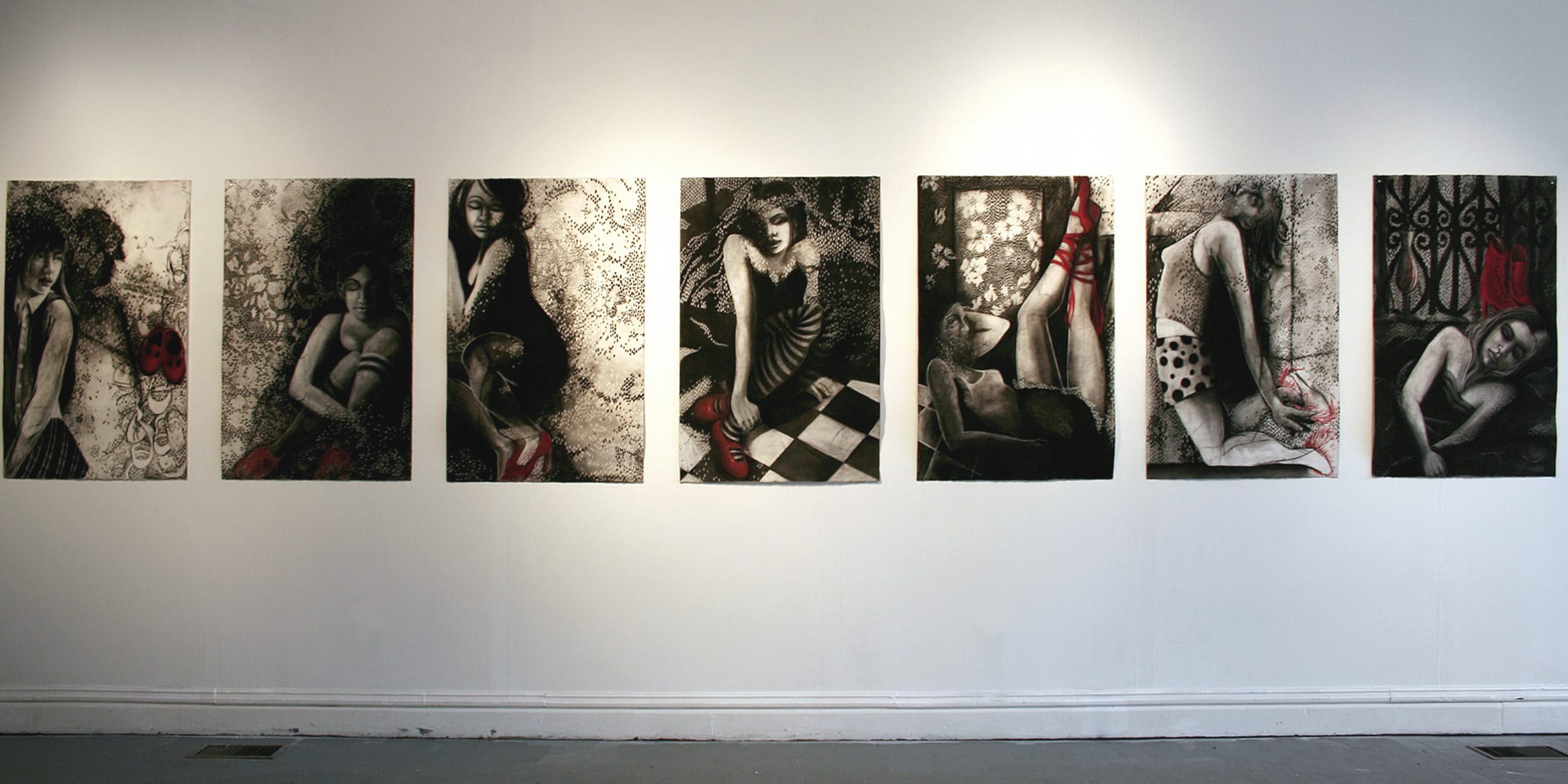 seven large-scale charcoal drawings hung on a gallery wall