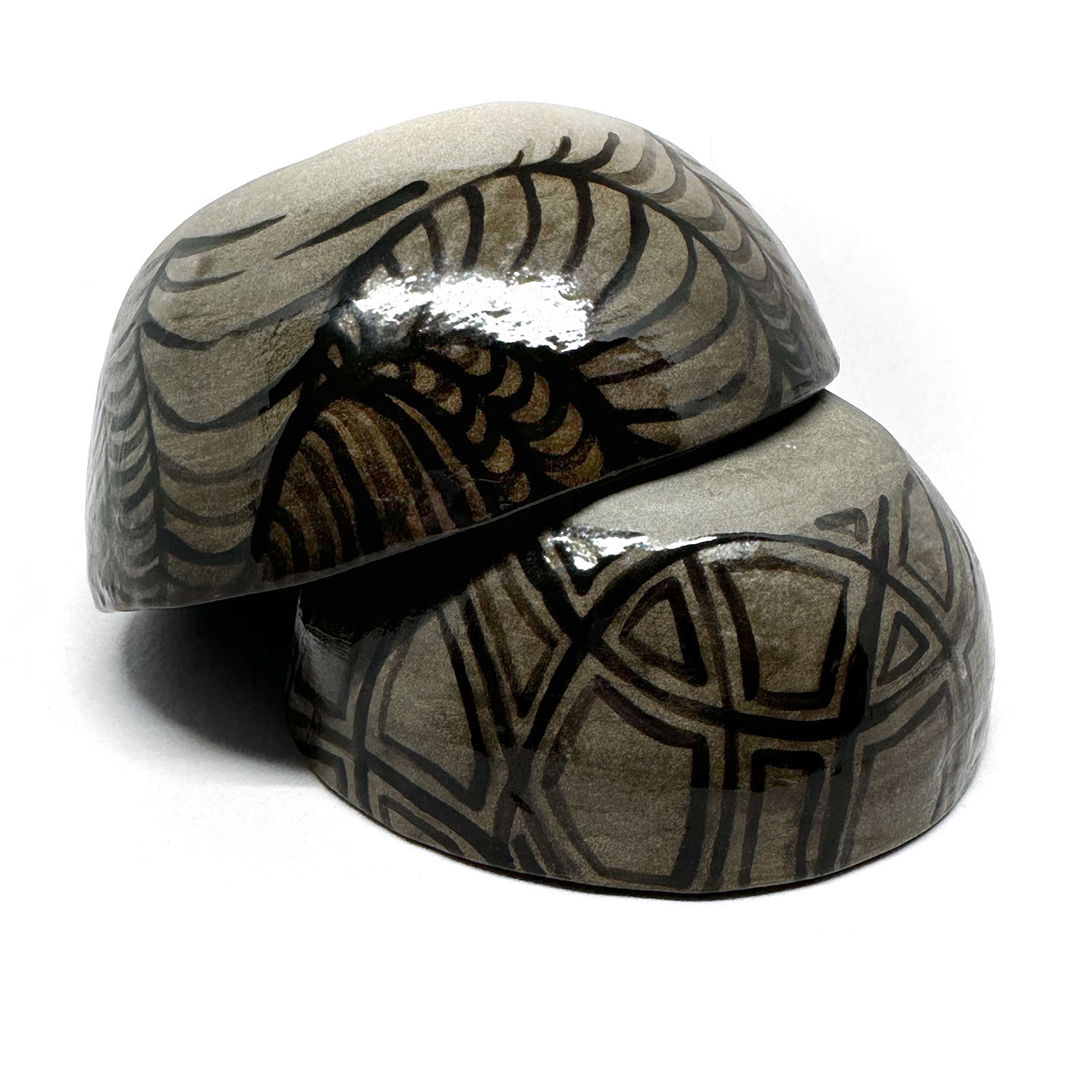 a dark grey ceramic plate with bubble-like patterns glazed in black