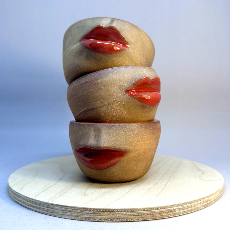 clay faces drying on a shelf